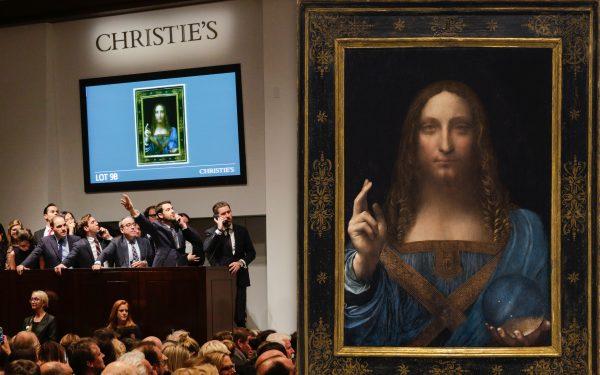 (L) Agents speak on their phones with their clients while bidding on at the auction of Leonardo da Vinci's "Salvator Mundi" during the Post-War and Contemporary Art evening sale at Christie's in New York City on Nov. 15, 2017. (Eduardo Munoz Alvarez/Getty Images) (R) “Salvator Mundi,” circa 1500, by Leonardo da Vinci (1452–1519). Oil on walnut wood panel, 25 7/8 inches by 18 inches, private collection. (Christie’s)