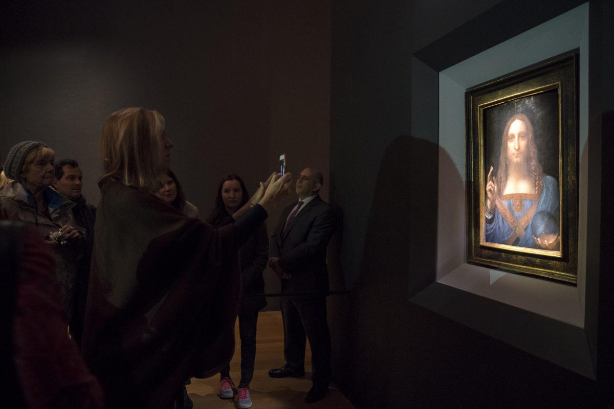Visitors view the painting "Salvator Mundi" by Leonardo da Vinci at Christie's in New York on Nov. 15, 2017. (Drew Angerer/Getty Images)