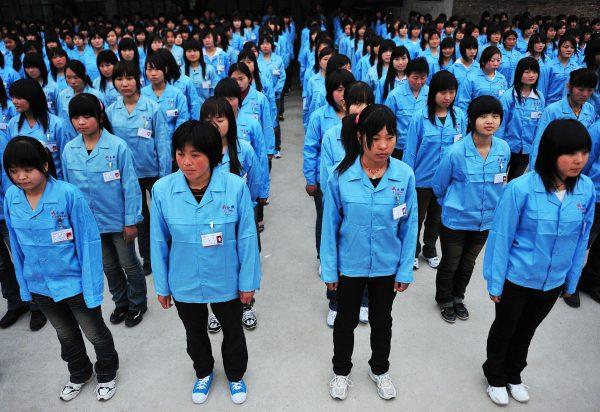 Workers prepare to depart for a factory in Shenzhen City, Guangdong Province, China, on February 26, 2009. (China Photos/Getty Images)