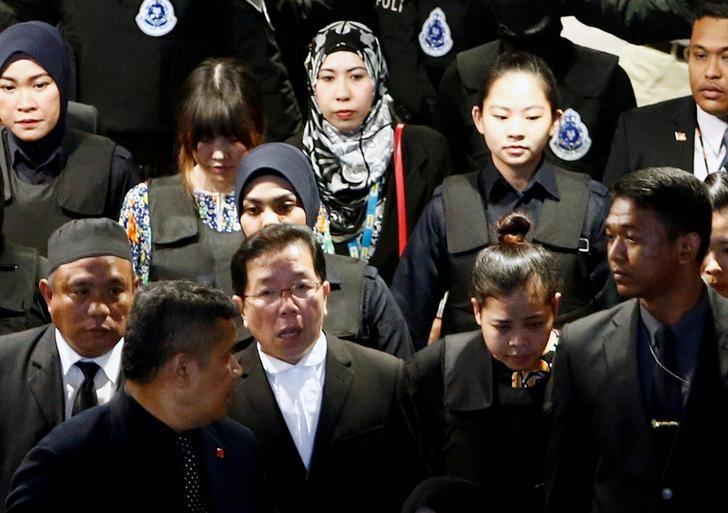 Indonesian Siti Aisyah and Vietnamese Doan Thi Huong, who are on trial for the killing of Kim Jong Nam, the estranged half-brother of North Korea's leader, are escorted as they revisit the Kuala Lumpur International Airport 2 in Sepang, Malaysia Oct. 24, 2017. (Reuters/Lai Seng Sin/Files)