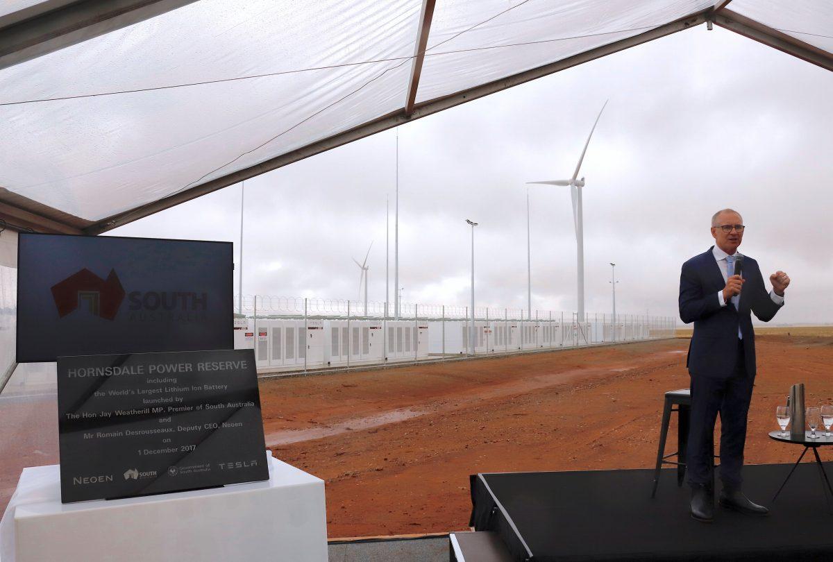 South Australian Premier, Jay Weatherill speaks as he stands next to a plaque during the official launch of the Hornsdale Power Reserve, featuring the world's largest lithium ion battery made by Tesla, near the South Australian town of Jamestown, in Australia, Dec. 1, 2017. (Reuters/David Gray)