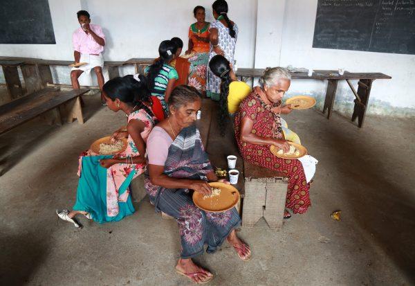 People eat in a relief camp after they were evacuated from their homes, after flooding caused by Cyclone Ockhi in the coastal village of Chellanam in the southern state of Kerala, India, December 2, 2017. (Reuters/Sivaram V)