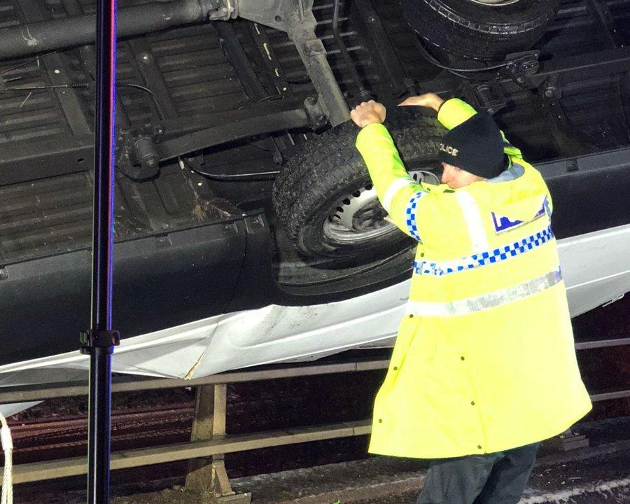 Hero Policeman Stops an Overturned Van Falling Off a Bridge With Driver Trapped Inside