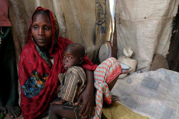 Falmata Alwana, an internally displaced person living in Bama camp, Nigeria, poses for a picture with one of her children in her shelter November 23, 2017. Picture taken November 23, 2017. REUTERS/Paul Carsten