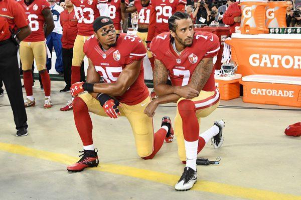 FILE—Eric Reid (L) and  Colin Kaepernick kneel in protest during the national anthem on Sept. 12, 2016. (Thearon W. Henderson/Getty Images)