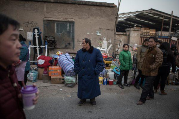 Residents standing outside their homes, after they received eviction notices, on the outskirts of Beijing, on November 27, 2017. (Fred Dufour/AFP/Getty Images)