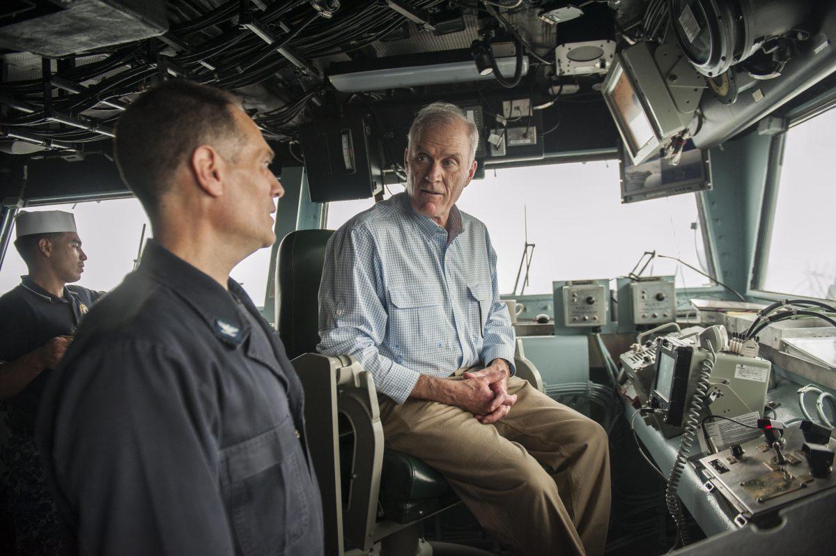 Secretary of the Navy, Richard V. Spencer speaks to Capt. Joseph Olson, the commanding officer of the amphibious assault ship USS America (LHA 6), during his visit on Thanksgiving Day on Nov. 23. (Courtesy of Mass Communication Specialist Seaman Chad Swysgood/U.S. Navy)