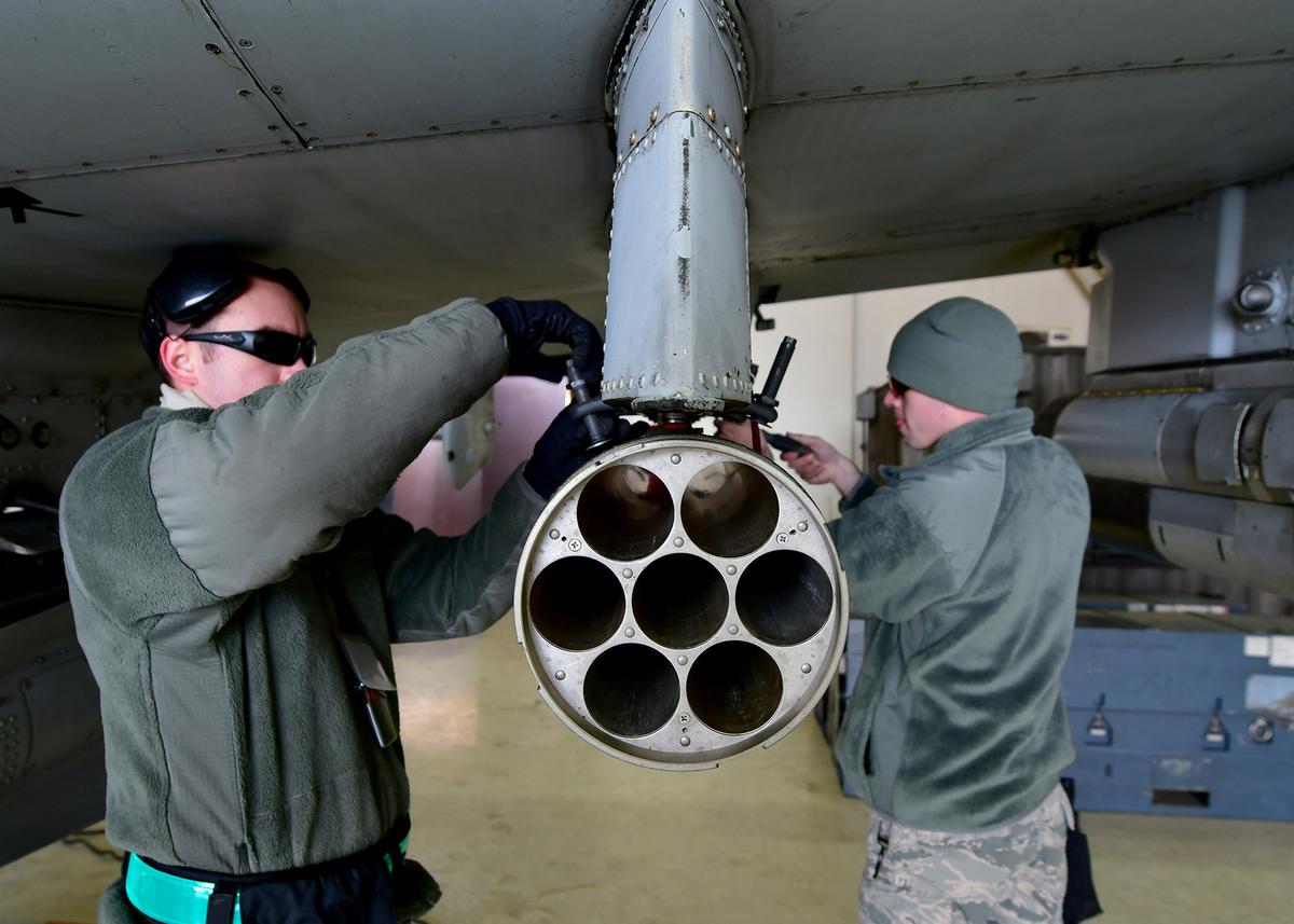 U.S. Air Force Senior Airmen with the 25th Fighter Squadron weapons load crew remove a weapon system from an A-10 Thunderbolt II aircraft during exercise Vigilant Ace 18 at Osan Air Base.  (U.S. Air Force photo by Staff Sgt. Franklin R. Ramos)