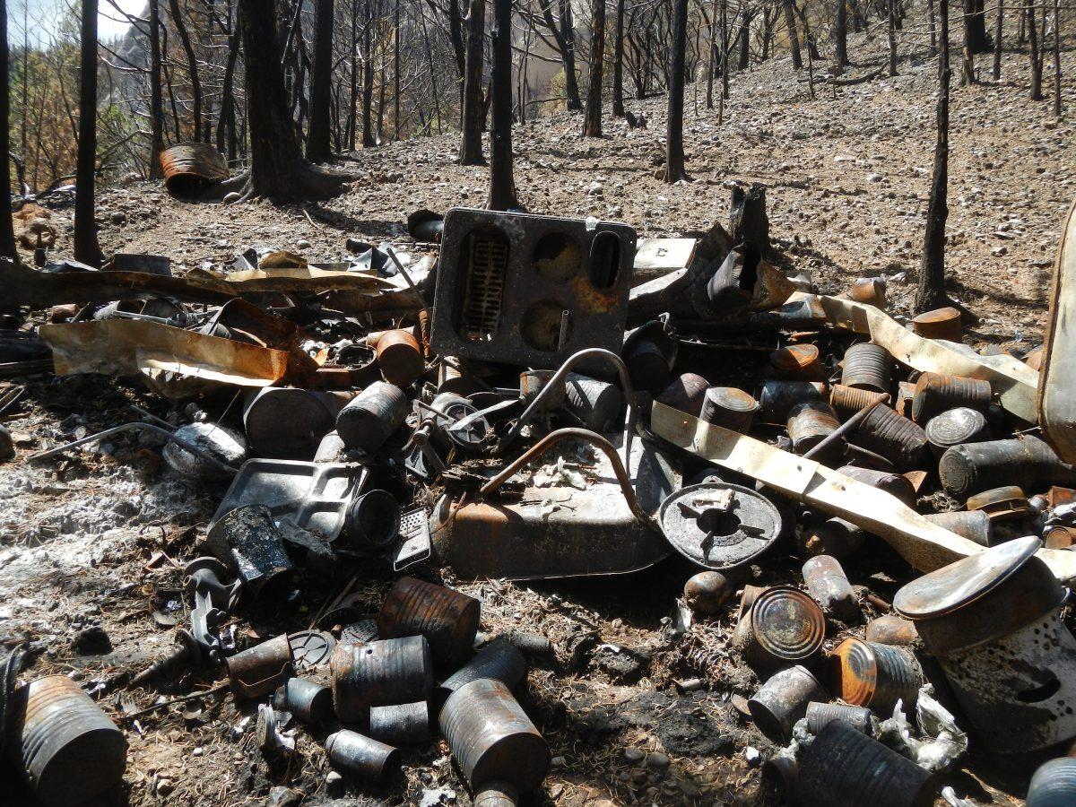 What remains of a burned-down cabin in which an 80-year-old Utah survivalist stockpiled food, weapons, and ammunition in the Cedar Mountain area. (Iron County Sheriff’s Office)