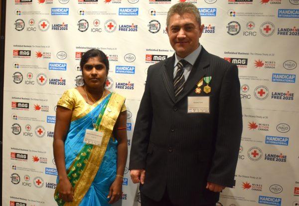 Krishnaveni Kaneshan of Sri Lanka (L), who works for international mine clearance NGO HALO Trust, and Alexander Thoric of Ukraine, a former military engineer in Ukraine who works as a de-miner, at the Ottawa Treaty 20th anniversary conference in Ottawa on Dec. 4, 2017. (Susan Korah)