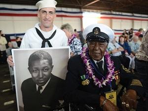 Carl Clark, a Pearl Harbor survivor and retired Navy Chief Petty Officer, smiles for a photo with a Navy sailor at the 75th Commemoration of the attack on Pearl Harbor at Kilo Pier, Joint Base Pearl Harbor-Hickam, Oahu, Dec. 7, 2016. (U.S. Coast Guard photo by Petty Officer 2nd Class Tara Molle)