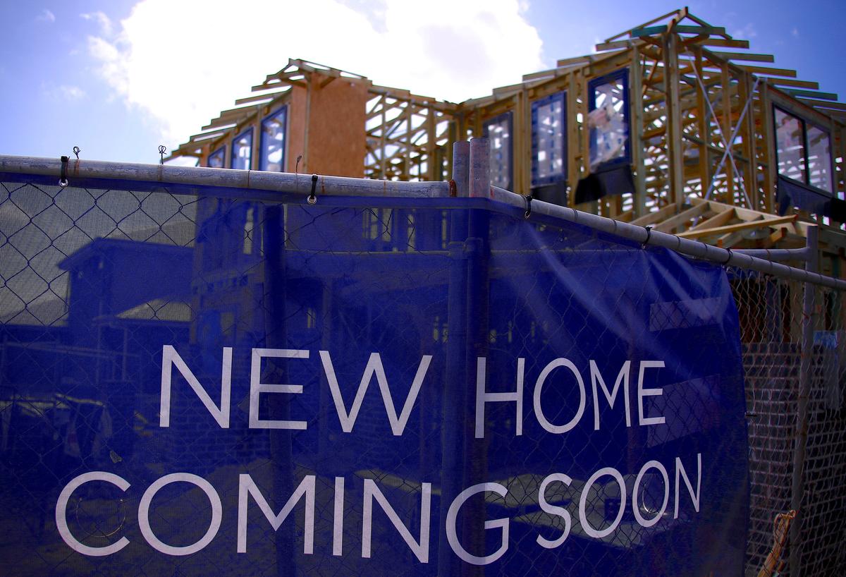 A house under construction can be seen behind an advertising banner at a housing development located in the western Sydney suburb of Oran Park in Australia, Oct. 21, 2017. (Reuters/David Gray/File Photo)