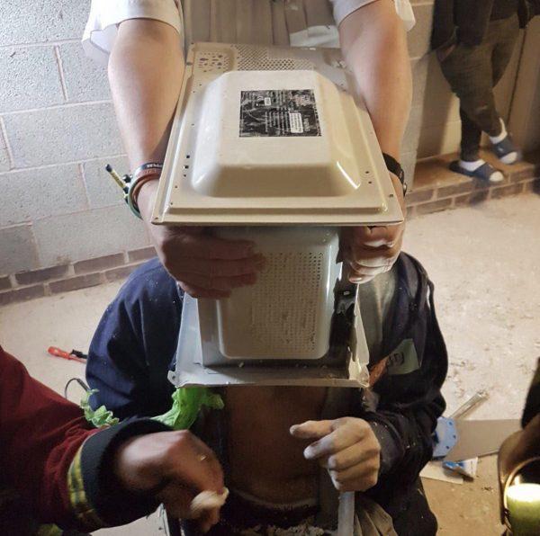 Firefighters spent an hour freeing the YouTuber who cemented his head into a microwave. (West Midlands Fire Service)