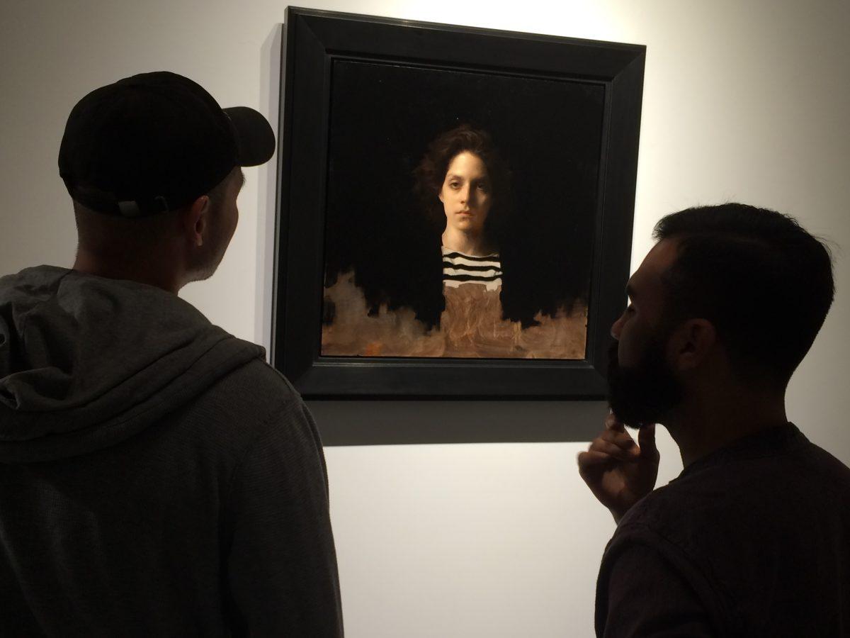 Two men look at Jordan Sokol's painting, "Crimson" at Arcadia Contemporary gallery in Culver City, Calif., in November 2017. (Courtesy of Arcadia Contemporary)