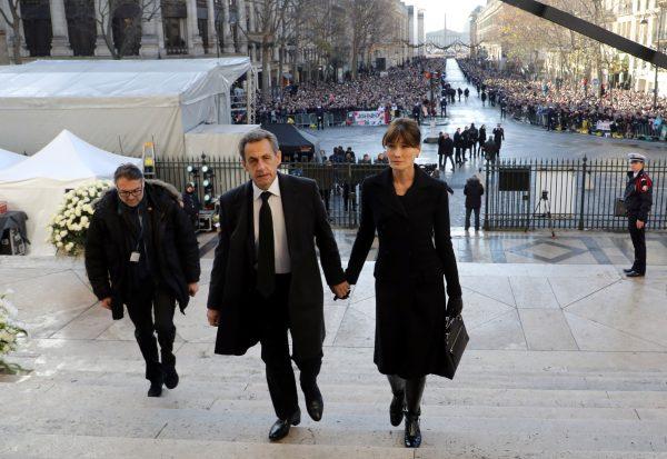 Former French President Nicolas Sarkozy (L) and his wife Carla Bruni-Sarkozy arrive at the La Madeleine Church to attend a ceremony in tribute to late French singer and actor Johnny Hallyday in Paris, France, December 9, 2017. (Reuters/Ludovic Marin/Pool)