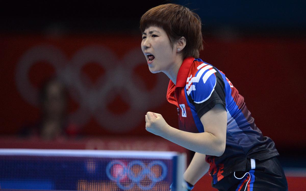 Tang Na, now named Dang Yeseo, plays for South Korea against Tie Yana of Hong Kong, during a table tennis women's team match of the London 2012 Olympic Games on Aug. 04, 2012. (Saeed Khan/AFP/Getty Images)