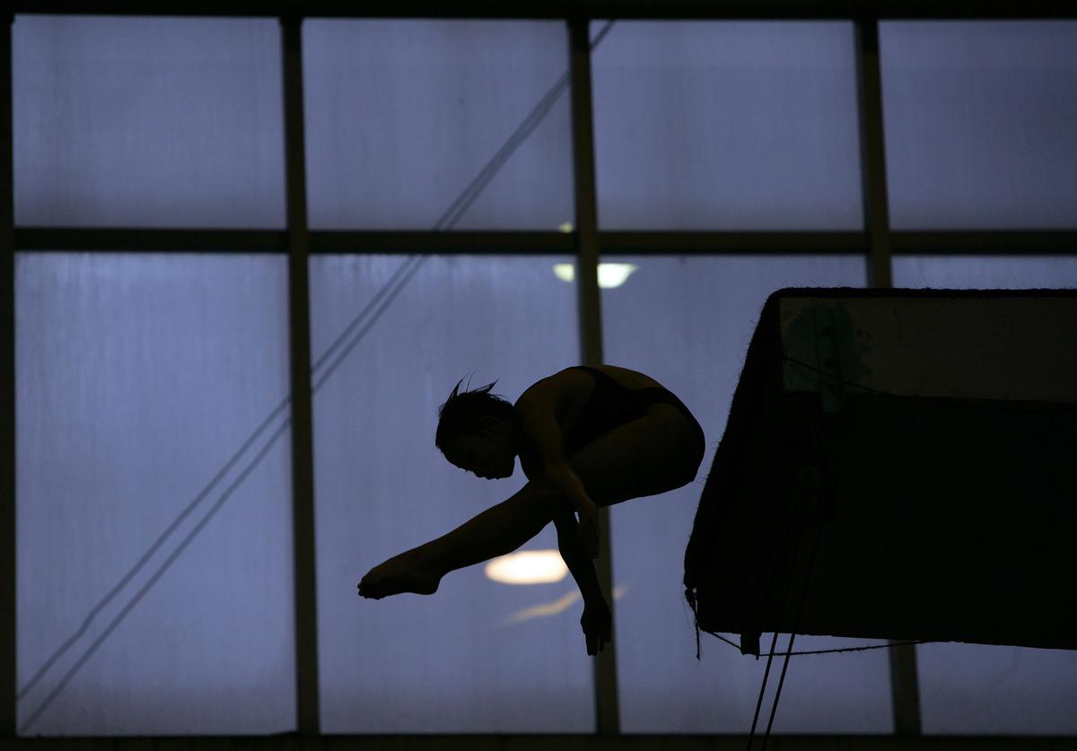 A member of the Chongqing Sports Technique School Diving Team practices during a training session in Chongqing, China, on Oct. 25, 2007. Olympic diving champion Tian Liang once trained here. (China Photos/Getty Images)