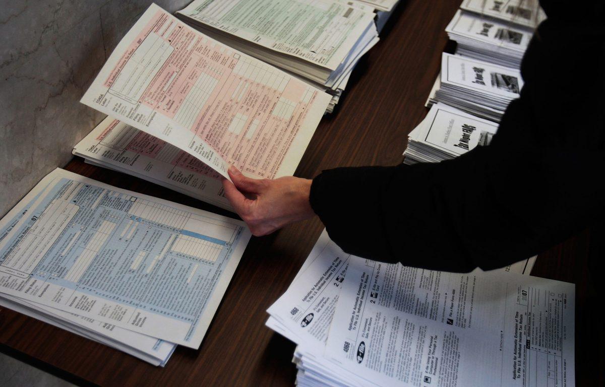 A woman picks up tax forms in the lobby of the Farley Post Office in New York City in a file photo. (Chris Hondros/Getty Images)