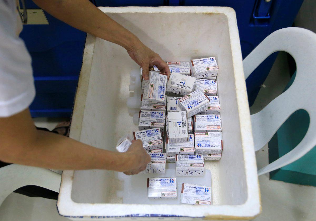 A health worker collects unused packs of anti-dengue vaccine Dengvaxia as she returns it inside a freezer for storage at the Manila Health Department in Sta Cruz, metro Manila, Philippines Dec. 5, 2017. (Reuters/Romeo Ranoco)