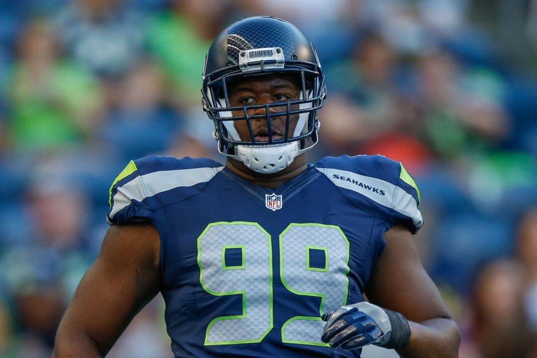 Seahawks Player Attempts to Climb Stands After Fan Throws Drink