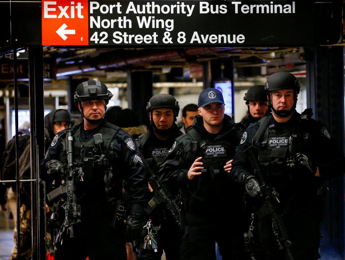 Members of the Port Authority Police Counter Terrorism unit patrol the subway corridor, at the New York Port Authority subway station near the site of an attempted detonation the day before, during the morning rush. (Reuters/Brendan McDermid)