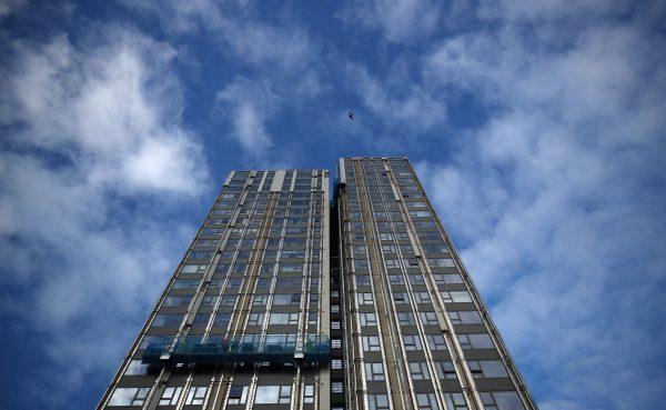 Workers remove cladding from Burnham Tower on the Chalcots estate in north London, on Nov. 30, 2017. Picture taken Nov. 30, 2017. (Reuters/Hannah McKay)