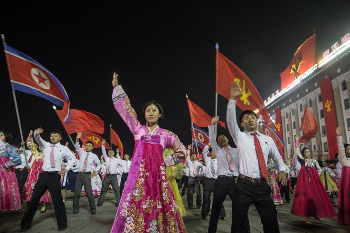 In a photo taken on Oct. 8, 2017, participants described as "working people, youth, and students of Pyongyang" perform during a mass gala event marking the 20th anniversary of late North Korean leader Kim Jong Il's election as general secretary of the Workers' Party of Korea (WPK) on Kim Il-Sung square in central Pyongyang. <br/>(KIM WON-JIN/AFP/Getty Images)