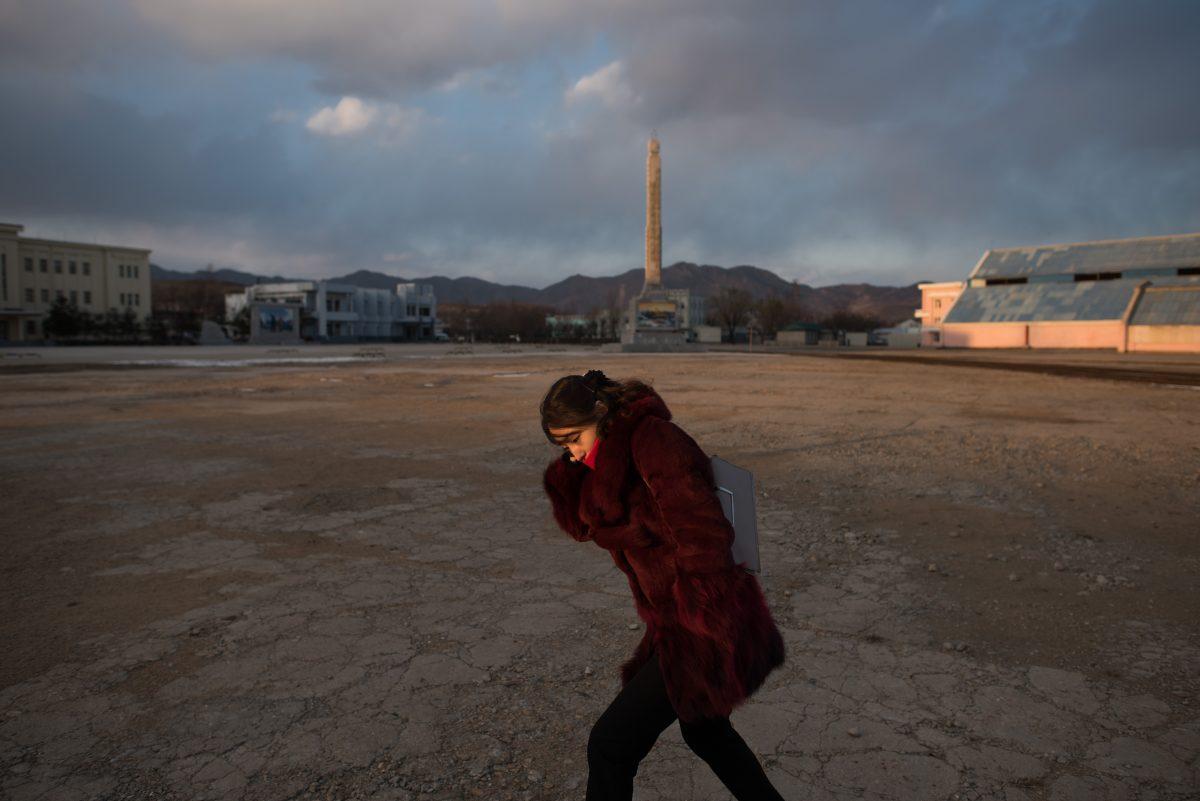 In a photo taken on Nov. 21, 2017, a woman shields herself from the cold at the port in Rason at the northeastern tip of North Korea, where the isolated, nuclear-armed country meets its giant neighbors China and Russia. (ED JONES/AFP/Getty Images)