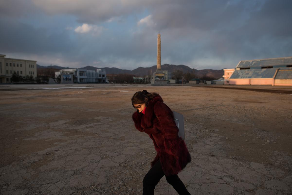 In a photo taken on Nov. 21, 2017, a woman shields herself from the cold at the port in Rason, North Korea. (Ed Jones/AFP/Getty Images)