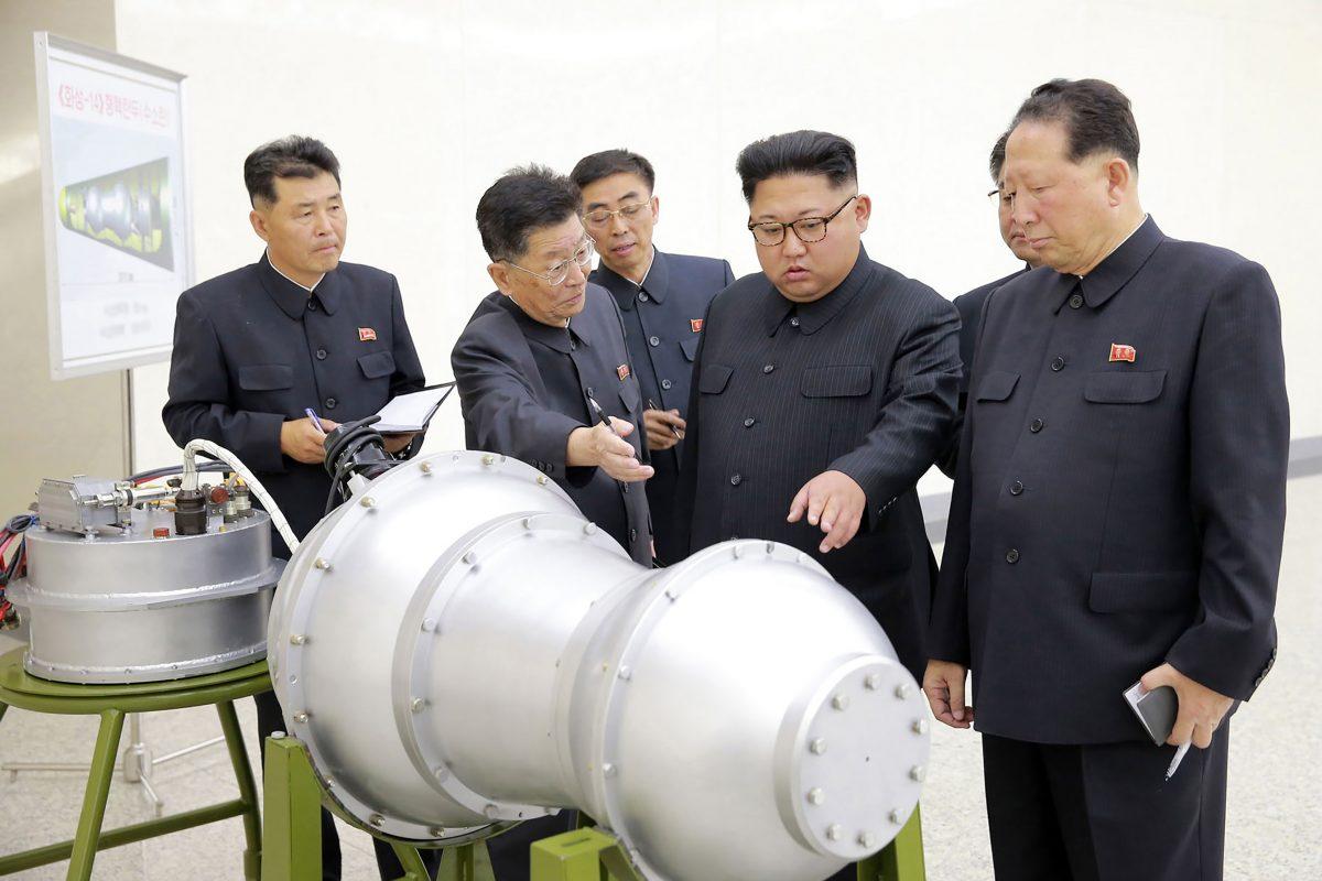 This undated picture released by North Korea's official Korean Central News Agency (KCNA) on Sept. 3, 2017 shows North Korean leader Kim Jong-Un (C) looking at what the regime claims is a hydrogen bomb that can be loaded into the country's new intercontinental ballistic missile. Analysts have raised doubts that the regime had managed to miniaturize its nuclear weapon, or that it had even managed to develop a thermonuclear hydrogen bomb. (STR/AFP/Getty Images)