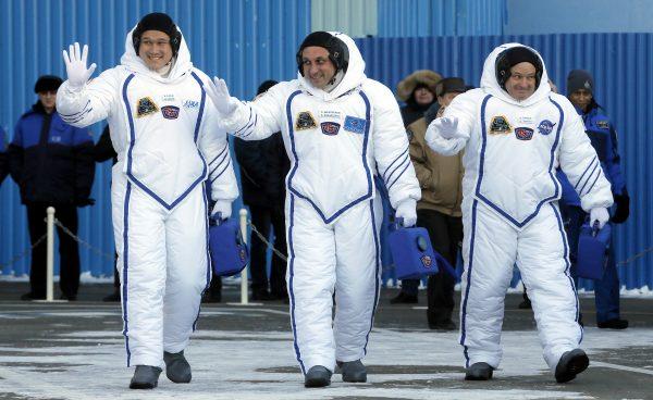Members of the International Space Station expedition 54/55, Roscosmos cosmonaut Anton Shkaplerov (C), NASA astronaut Scott Tingle (R) and Norishige Kanai (L) of the Japan Aerospace Exploration Agency (JAXA) during the send-off ceremony after checking their space suits before the launch of the Soyuz MS-07 spacecraft at the Baikonur cosmodrome, in Kazakhstan, 17 December 2017. (Reuters/Maxim Shipenkov/Pool)