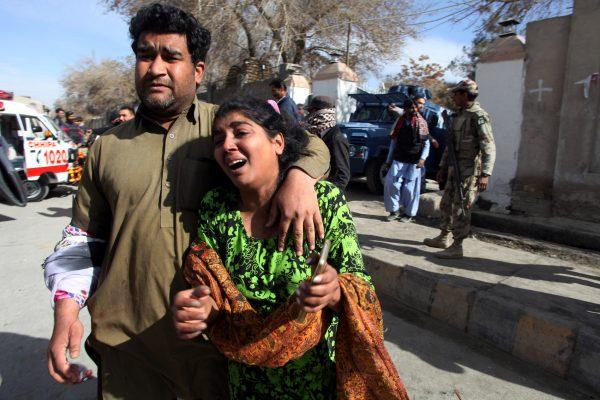 A man and a woman react as they run out after gunmen attacked the Bethel Memorial Methodist Church in Quetta, Pakistan December 17, 2017. (Reuters/Naseer Ahmed)