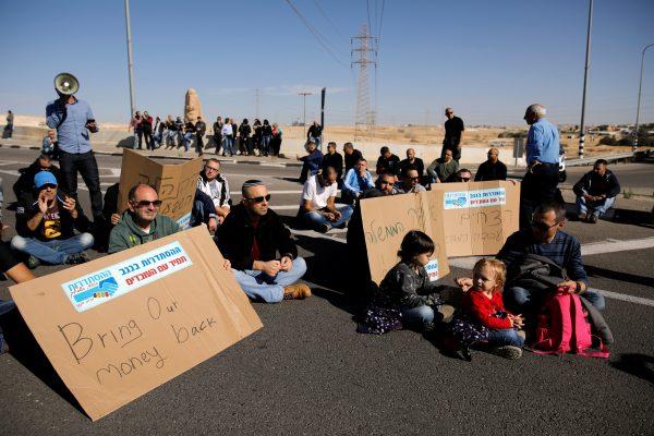 Worker of Teva Pharmaceutical Industries block a road during a demonstration near the facility in Neot Hovav, southern Israel December 17, 2017. (Reuters/Amir Cohen)