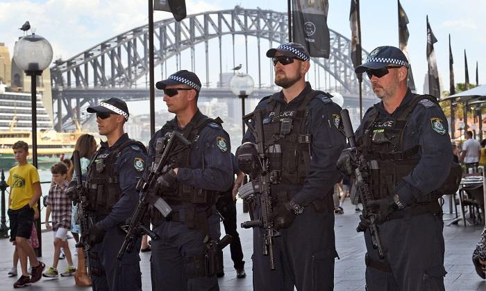 Members of the New South Wales (NSW) state riot squad police were called to assist in the raid on a property where alleged climate activists were said to be training. NSW Riot squat seen here carrying Colt M4 semi-automatic rifles, which are now being used during large gatherings over the holidays as part of an increase in security against terrorism. (William West/AFP/Getty Images)