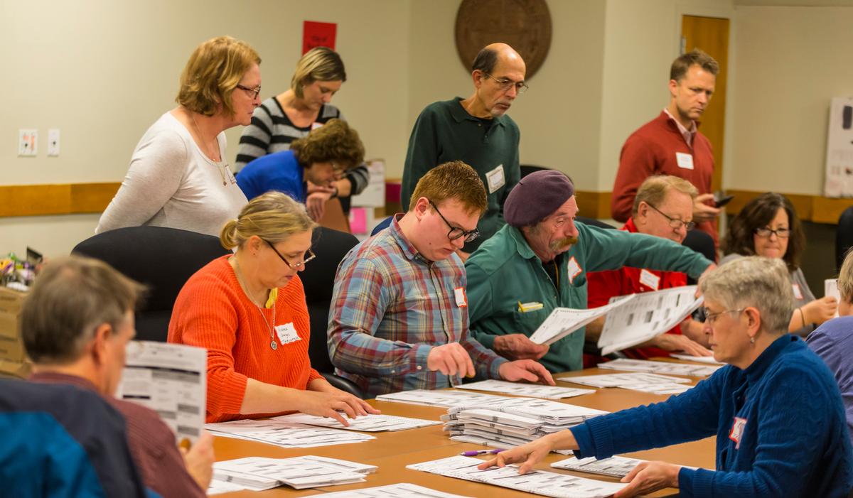 Designated observers watch as tabulators work on recounting presidential ballots in Dane County (Wis.) in Madison, Wis., Dec. 1, 2016. (Andy Manis/Getty Images)