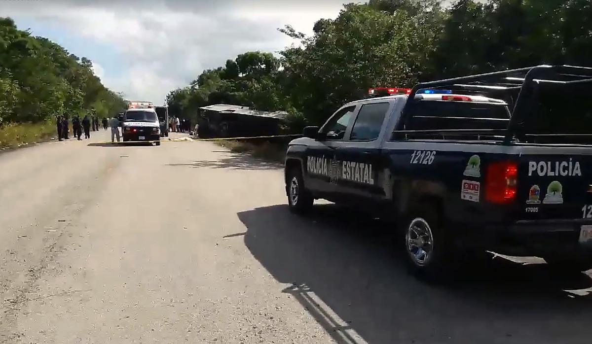 Video grab of a police van and ambulance seen in the area where a bus driving tourists to Chacchoben archaeological zone overturned, in the road between El Cafetal and Mahahual, in Quintana Roo state, Mexico on Dec. 19, 2017. (Manuel Jesus Ortega Canche/AFP/Getty Images)