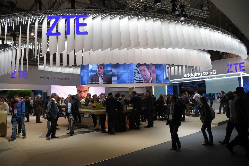 Visitors pass in front of the ZTE stand on the first day of the Mobile World Congress in Barcelona on Feb. 27, 2017. (Lluis Gene/AFP/Getty Images)