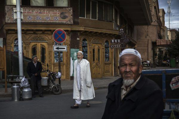 Uyghur men at a local market in Kashgar, Xinjiang, on July 1. (Kevin Frayer/Getty Images)
