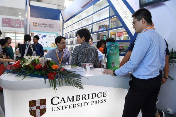 People gather at the Cambridge University Press stand at the Beijing International Book Fair in Beijing, on Aug. 23, 2017. (Greg Baker/AFP/Getty Images)