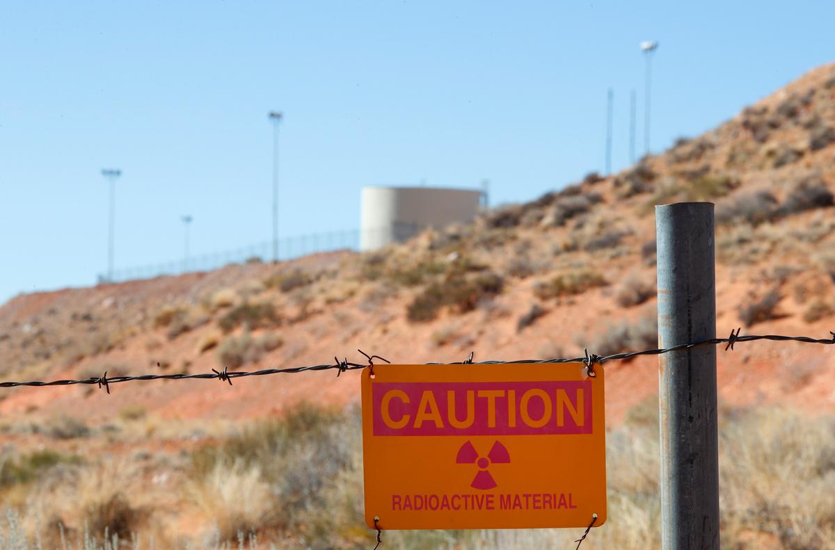 A radioactive warning sign hangs on fencing around the Anfield's Shootaring Canyon Uranium Mill on October 27, 2017, outside Ticaboo, Utah. Anfield with is in partnership with the Russian firm Uranium One, and bought the mill from Uranium One in 2015. (George Frey/Getty Images)