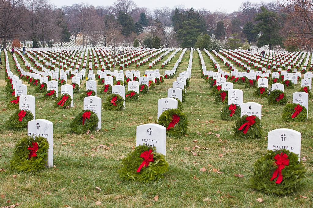 Volunteers with Wreaths Across America help place more than 100,000 remembrance wreaths on headstones at Arlington National Cemetery, Va., Dec. 13, 2013. The mission of Wreaths Across America is to remember and honor the fallen men and women of the armed forces by coordinating wreath laying ceremonies. (U.S. Army photo by Spc. James K. McCann)