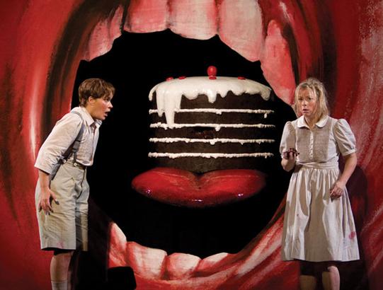 Hansel (Kate Lindsey) and Gretel (Alexandra Kurzak) are enticed by a giant cake at the entrance to the Witch’s Factory, in the Metropolitan Opera’s production of “Hansel and Gretel.” (Marty Sohl/Metropolitan Opera)