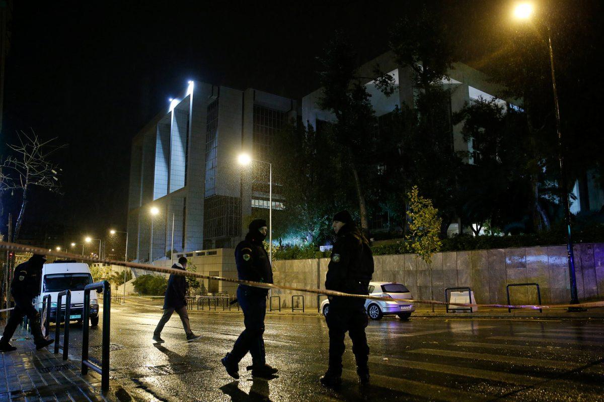 Greek policemen secure the area after a bomb blast at a court building in Athens, Greece, Dec. 22, 2017. (REUTERS/Costas Baltas)