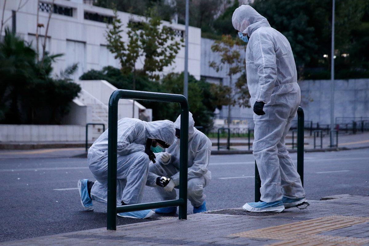 Police officers search for evidence after a bomb blast at a Court building in Athens, Greece, Dec. 22, 2017. (Reuters/Costas Baltas)
