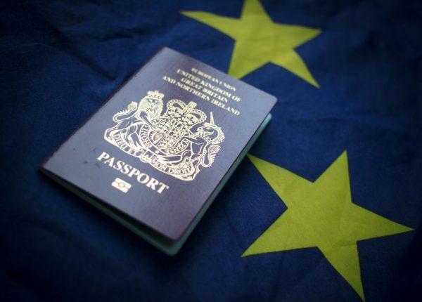 A British passport in front of the flag of the European Union. (Matt Cardy/Getty Images)