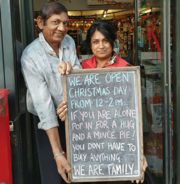 Shashi and Pallu Patel run a convenience store in Twickenham, near London, and are inviting anybody who's alone on Christmas to stop by for a hug and a treat. (Photo courtesy of Meet and Deep Newsagents)