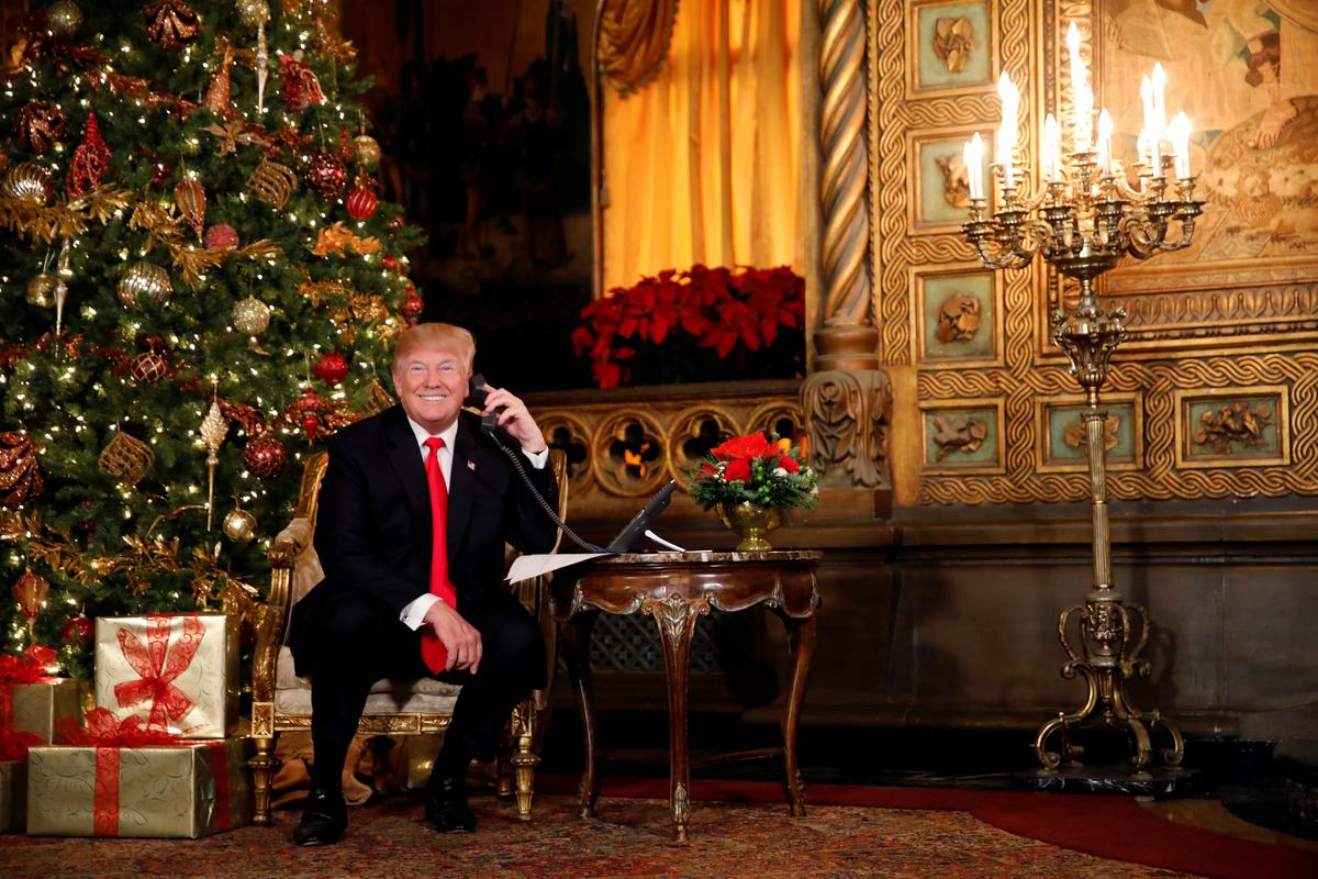 President Donald Trump participates in NORAD (North American Aerospace Defense Command) Santa Tracker phone calls with children at Mar-a-Lago estate in Palm Beach, Fla., on Dec. 24, 2017. (REUTERS/Carlos Barria)