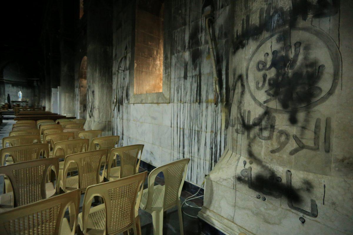 ISIS graffiti is seen inside the church of the Immaculate Conception in the town of Qaraqosh, south of Mosul, Iraq Dec. 23, 2017. (Reuters/Ari Jalal)