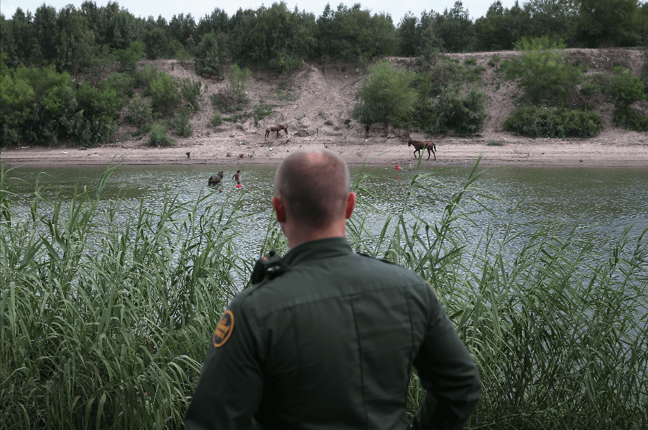 A Border Patrol agent looks towards Mexico from the bank of the Rio Grande near McAllen, Texas, on Sept. 8, 2014. The Rio Grande Valley area is the busiest sector for illegal border crossings into the United States. (John Moore/Getty Images)