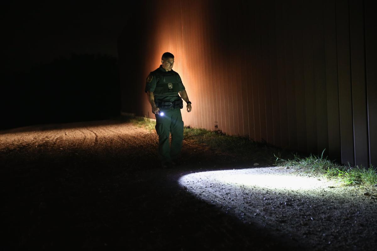 A Border Patrol agent checks for illegal immigrant tracks near the border fence along the Rio Grande in Weslaco, Texas, April 13, 2016. (John Moore/Getty Images)